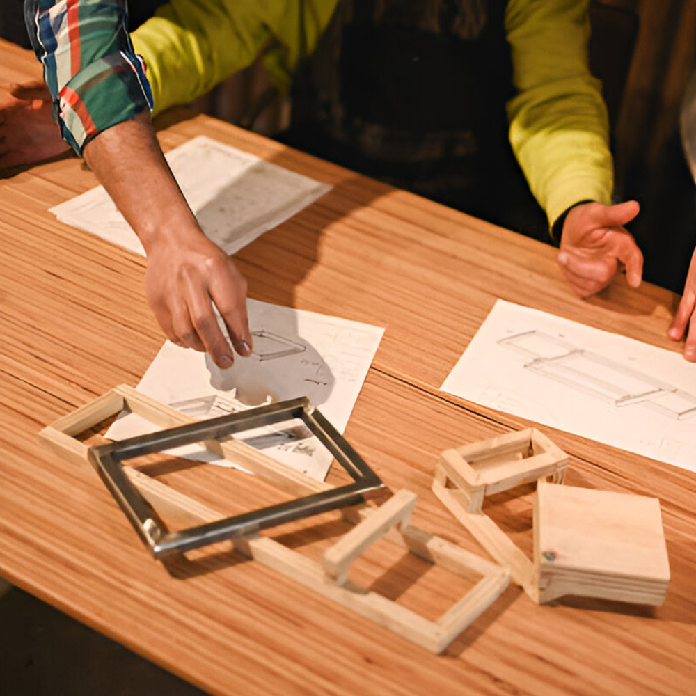 Team reviewing drawings and a rack frame model